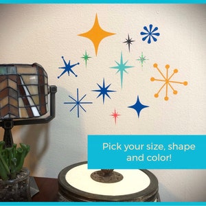 May include: A white wall with a variety of colorful star and sunburst shapes in different sizes. The text "Pick your size, shape and color!" is at the bottom of the image.