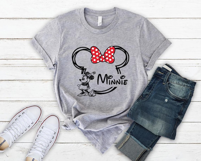 May include: Gray t-shirt with a black and white illustration of Minnie Mouse with a red bow and the text "Minnie" underneath.