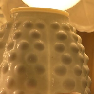 May include: A set of three ceramic mugs with a speckled, matte finish. The mugs are in shades of cream, light brown, and dark brown. Each mug has a rounded handle and a simple, minimalist design.