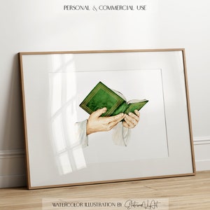 Puede incluir: Ilustraci&oacute;n de acuarela de un par de manos sosteniendo un libro verde abierto. El libro tiene un lomo dorado y est&aacute; decorado con un dise&ntilde;o floral.