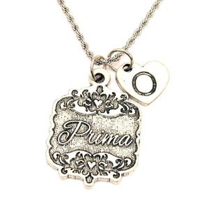 May include: Silver necklace with a charm that says "Prima" and a heart charm with the letter "O" engraved on it.