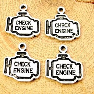 May include: Four silver-colored metal charms shaped like a car engine with the words "Check Engine" inscribed on each charm.