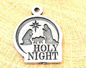 May include: A silver charm featuring a depiction of the nativity scene with the words "HOLY NIGHT".