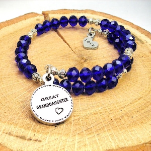 May include: A blue crystal beaded bracelet with a silver charm that says "Great Granddaughter" and a small heart charm that says "Love".