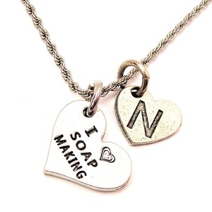 May include: Silver necklace with two heart-shaped charms. One charm says "I ♥ SOAP MAKING" and the other charm has the letter "N" on it.