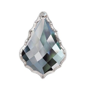 May include: A clear crystal teardrop pendant with a faceted design and a silver-toned metal frame.