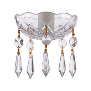 May include: A clear glass candle holder with a scalloped edge and diamond pattern. The holder has five crystal teardrop pendants with gold-colored accents. The candle holder is designed to hold a single candle.