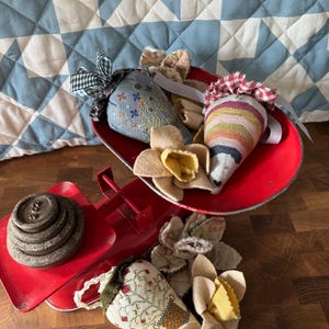 May include: A set of three ceramic mugs with a speckled, matte finish. The mugs are in shades of cream, light gray, and dark gray. Each mug has a simple, minimalist design and a rounded handle.