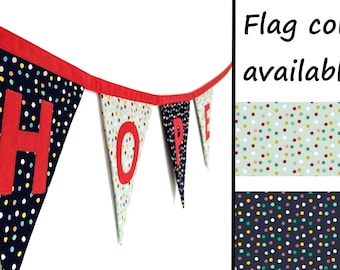 May include: A bunting banner spelling "HOPE" with red letters and a colorful polka dot pattern on each flag. The bunting is strung with red string. The image shows two different color options for the bunting: a light green background with multi-colored dots and a dark blue background with multi-colored dots.