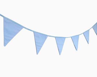 May include: A light blue bunting with triangular flags strung together. The bunting is made of fabric and is perfect for decorating a party or event.