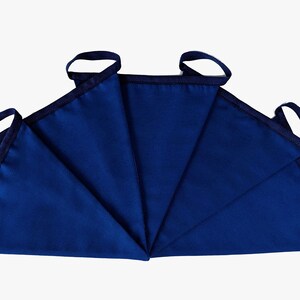 May include: A set of five blue fabric pennants with black trim and loops. The pennants are arranged in a fan shape.