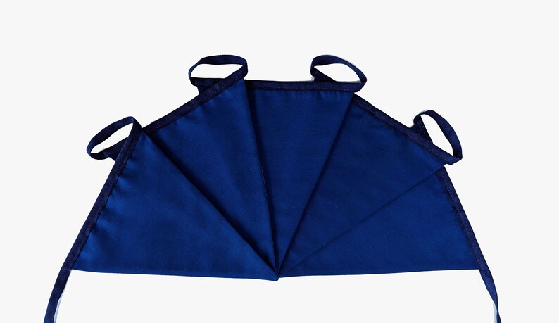 May include: A set of five blue fabric pennants with black trim and loops. The pennants are arranged in a fan shape.