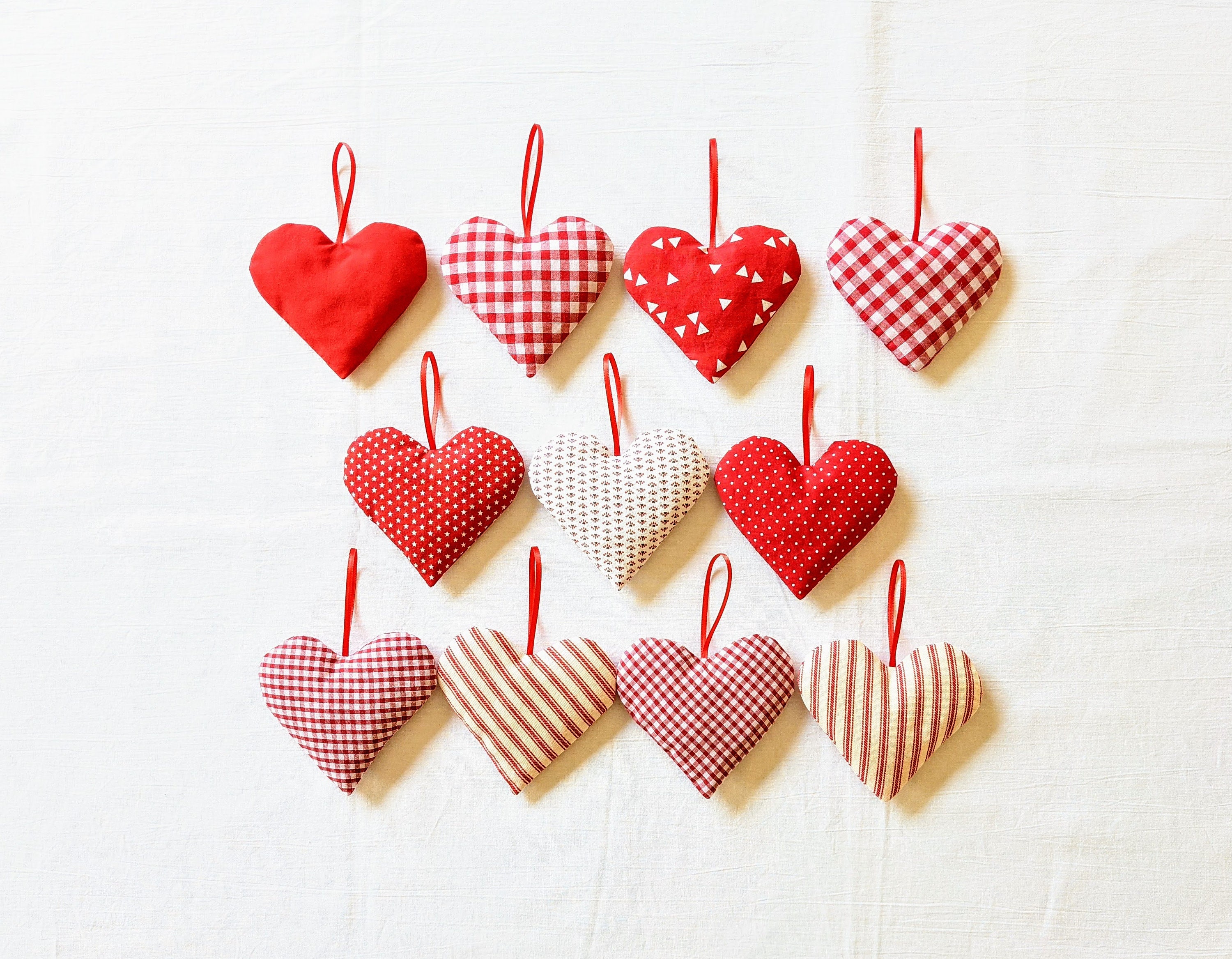 Red heart wooden tiny clothespins and swirl satin ribbon Stock Photo by  olhakozachenko_photo