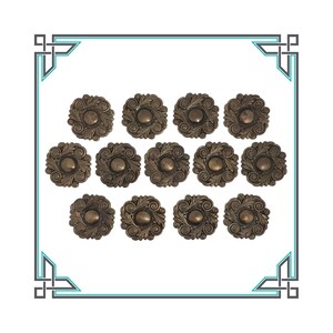 May include: A set of 15 antique-looking, gold-toned metal buttons with a decorative floral design.