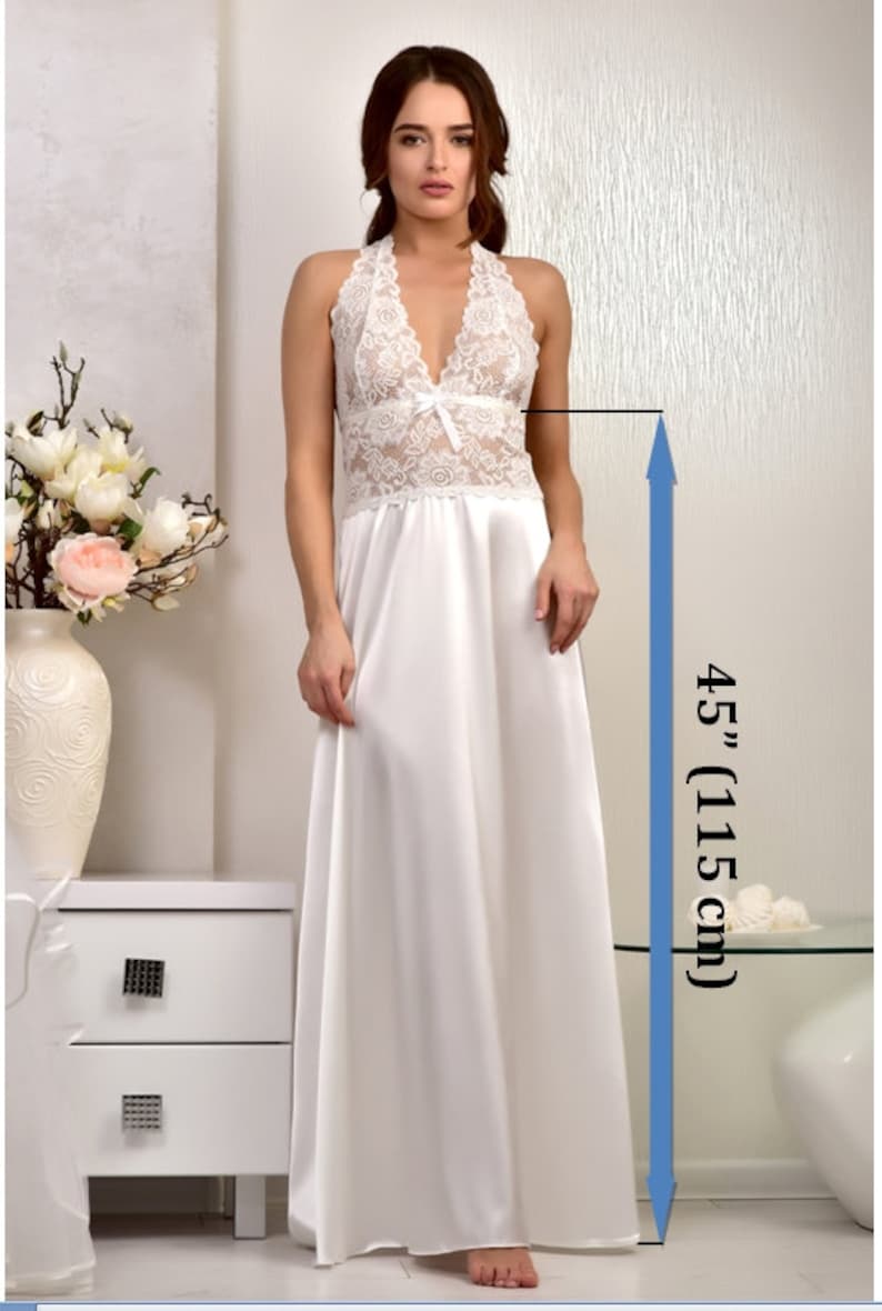 May include: White satin nightgown with lace detailing and a halter neckline. The gown is 45 inches (115 cm) long.