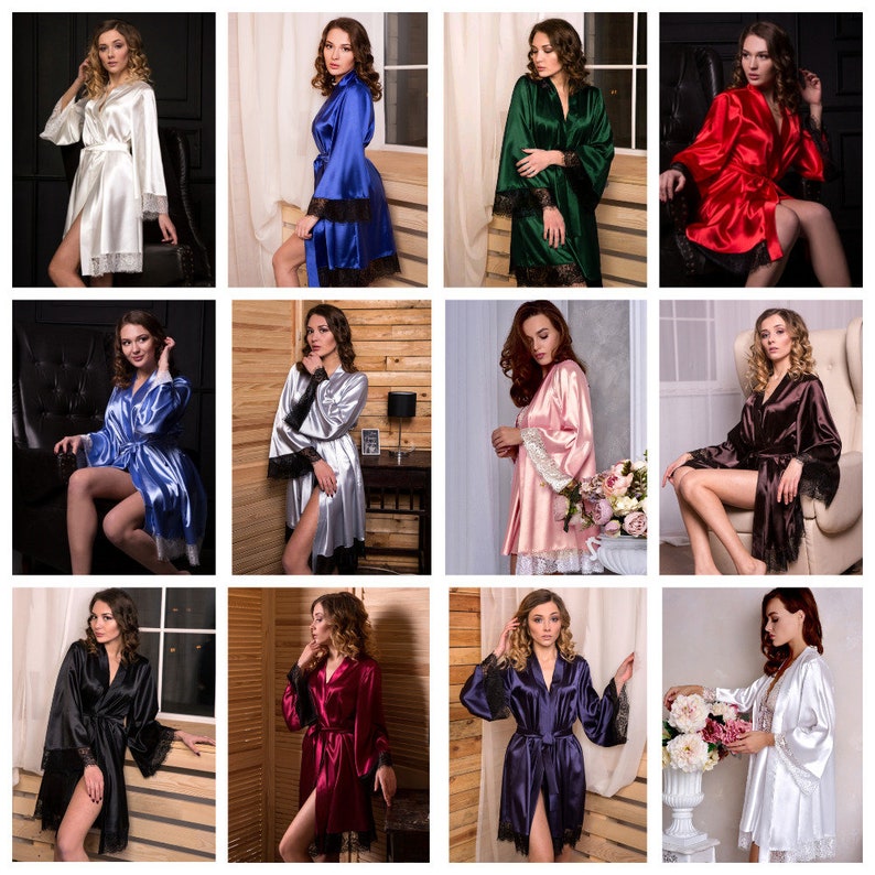 May include: A collection of 12 satin robes in various colours, featuring lace trim on the sleeves and neckline. The robes are shown on models in a variety of poses.