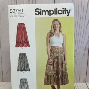 May include: Simplicity sewing pattern number S9750 for a skirt. The pattern includes three different skirt styles: a long, flowing skirt with a tiered design, a shorter skirt with a tiered design, and a skirt with a lace trim. The pattern is for sizes US 18-26, Talla Euro 44-52, and Taille FR 46-54.
