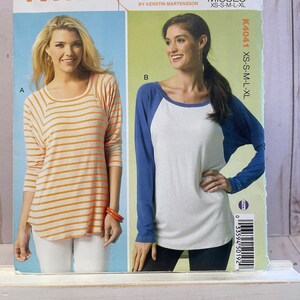 May include: Sewing pattern for two tops, one with orange and white stripes and the other with a blue and white baseball design. The pattern is for misses' sizes XS-S-M-L-XL. The pattern number is K4041.