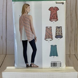 May include: A sewing pattern for a sleeveless top with a back opening. The pattern is from Newlook and is size 6-18, 34-48, 32-44. The pattern is called "easy" and has a barcode.