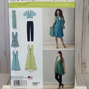 May include: Simplicity sewing pattern 1376 BB featuring various dress designs. The pattern includes a dress with a shawl, a sleeveless top, and pants. The pattern is printed in the USA and includes sizes 20W-28W.