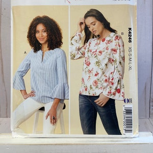 May include: A sewing pattern for a women's blouse with two different styles. The first style is a blue and white striped blouse with a V-neck and 3/4 sleeves. The second style is a white blouse with a floral print and 3/4 sleeves. The pattern is called "Kwik Sew" and the number is K4246. The pattern is for sizes XS-S-M-L-XL.