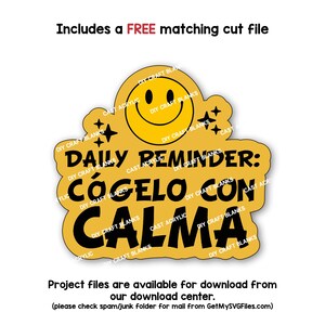 May include: A yellow circle with a smiley face and the text "Daily Reminder: Cógelo con Calma" in black. The text is surrounded by stars and the words "DIY Craft Blanks" in a smaller font.