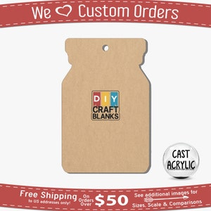 May include: A brown mason jar shaped craft blank with a hole at the top for hanging. The blank has a sticker on it that says "DIY CRAFT BLANKS" in black text on a red, yellow, blue, and green background. The blank is sitting on a white surface.
