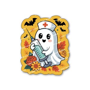 May include: A cartoon ghost in a nurse's hat with a red cross, holding a syringe. The design features bats, autumn leaves, and flowers on a yellow background. The words "DIY CRAFT BLANKS" are visible.
