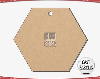 May include: A clear, hexagon-shaped acrylic blank with a pre-drilled hole for crafting. The image includes the text "We Custom Orders" and "DIY Craft Supplies". A small circle graphic reads "Cast Acrylic".