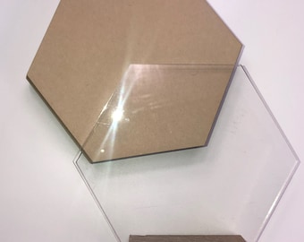May include: A hexagonal wooden plaque with a clear acrylic hexagon on top. The plaque is sitting on a wooden base.