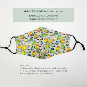 May include: A blue face mask with a repeating pattern of colorful parakeets. The mask has adjustable elastic ear loops and a nose wire. It is available in two sizes: small (7.5 inches by 5 inches) and large (9 inches by 6 inches).