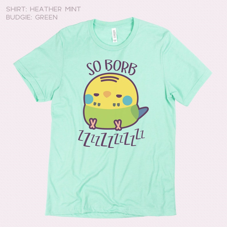 May include: A light green t-shirt featuring a cartoon green and yellow budgie. The budgie is sleeping and the text "SO BORB" is above it. The text "ZZZZZZZZZZ" is below the budgie.