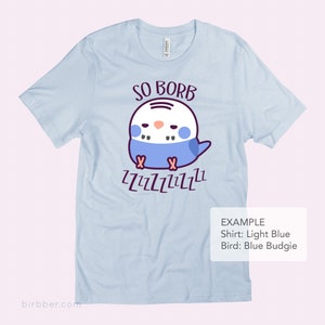 May include: Light blue t-shirt featuring a cartoon blue budgie sleeping and the text "SO BORB" and "ZZZZZZZZZZ".