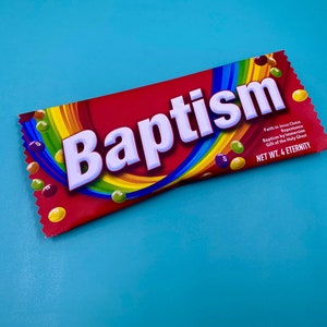 May include: A red candy wrapper with the word "Baptism" in large white letters. A rainbow design arcs across the wrapper, and colorful candies are scattered around. The text "NET WT. 4 ETERNITY" is also visible.