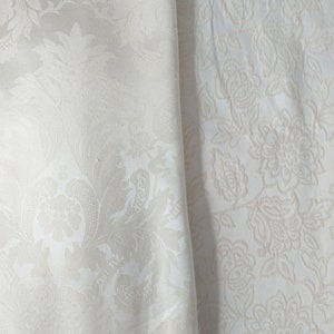 May include: Two fabric swatches, one labeled "butter" and the other "cream", both with a white embossed floral pattern.