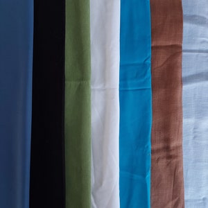 May include: Seven fabric swatches labeled 1 through 7. The swatches are in the following colors: blue, black, green, white, turquoise, brown, and light blue. The text "cotton and linen" is printed above the swatches.