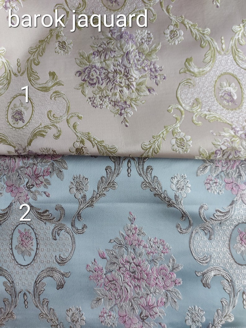May include: Two fabric swatches with a baroque floral pattern. The top swatch is a light pink color with a green and purple floral design. The bottom swatch is a light blue color with a green and pink floral design.