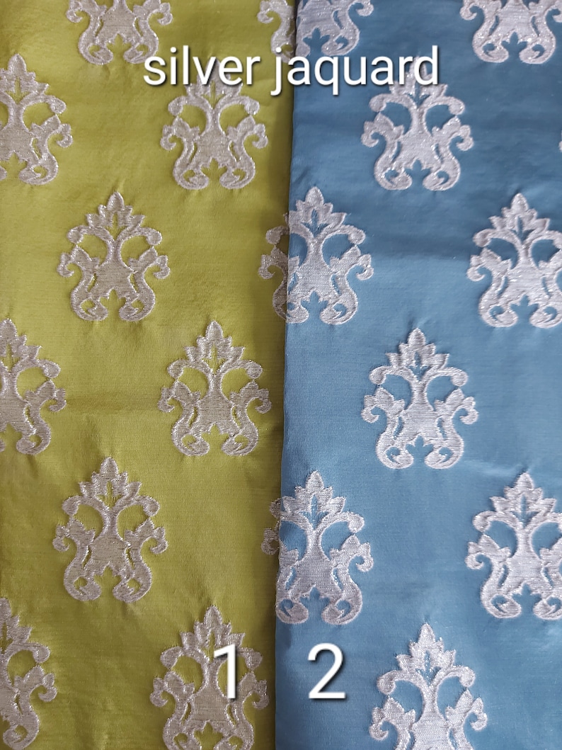 May include: Two fabric swatches with a silver jacquard pattern. The fabric on the left is a light green color and the fabric on the right is a light blue color. The text "silver jacquard" is printed at the top of the image. The numbers "1" and "2" are printed at the bottom of the image.