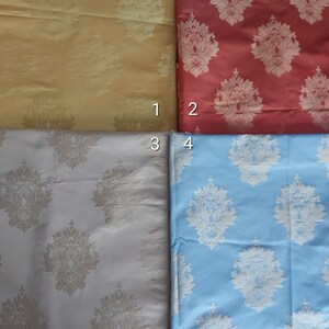 May include: Four fabric swatches with a damask pattern. The swatches are in the following colors: yellow, red, gray, and light blue.