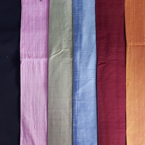 May include: Six fabric swatches labeled 1 through 6. The swatches are in the following colors: black, pink, light green, light blue, burgundy, and orange. The text "pure silk" is printed above the swatches.