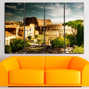 May include: A multi-panel canvas print featuring a panoramic view of the Colosseum in Rome, Italy. The image shows the ancient amphitheater, surrounding buildings, and a lush green landscape.