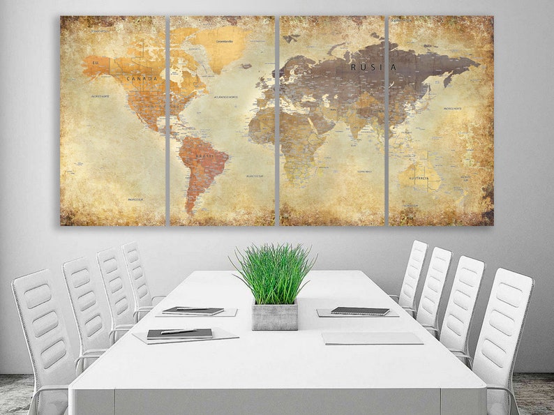 May include: A vintage-style world map print in four panels, featuring a distressed, aged look. The map is displayed on a white wall above a white conference table with white chairs and a potted green plant.