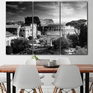 May include: A black and white photo of the Colosseum in Rome, Italy. The photo is split into three panels, showing the Colosseum from different angles. The photo is taken from a high vantage point, and the Colosseum is surrounded by trees and buildings.