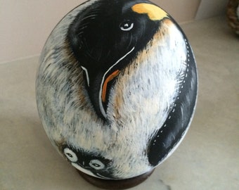 D ostrich egg a papa Penguin and her cub
