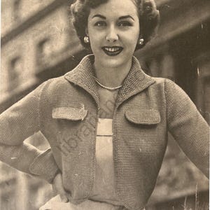 May include: A close-up of a woman wearing a knitted cardigan with a collared neckline and two flap pockets. The cardigan is a light brown colour and has a textured knit pattern. The woman is smiling and has her hair styled in a short, curly bob.