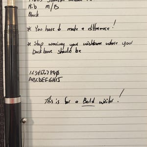 May include: A black 1960's Sheaffer School Pen with a gold nib, shown on lined paper. The text on the paper includes "You have to make a difference!" and "This is for a Bold writer!"