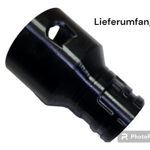Könnte beinhalten: Schwarzer Kunststoffadapter mit einem Loch und einem gerippten Design. Der Text "Lieferumfang" ist im Bild sichtbar.