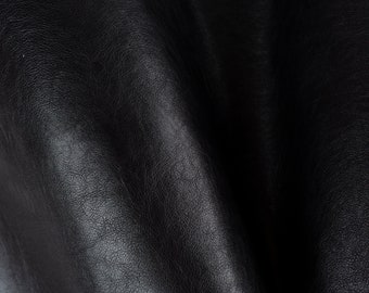 May include: Close-up of black leather with a textured surface.