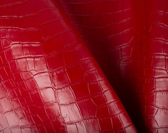 May include: Red faux leather with a crocodile embossed pattern.
