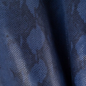 Peut inclure: Gros plan sur un tissu en peau de serpent bleu avec un motif texturé.